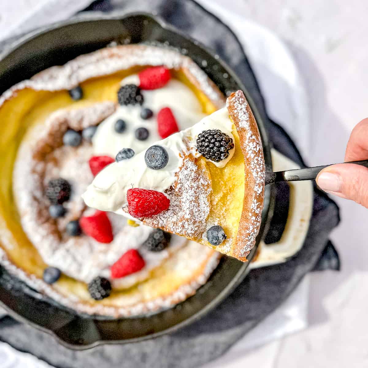 a slice of dutch baby with yogurt and fruit.