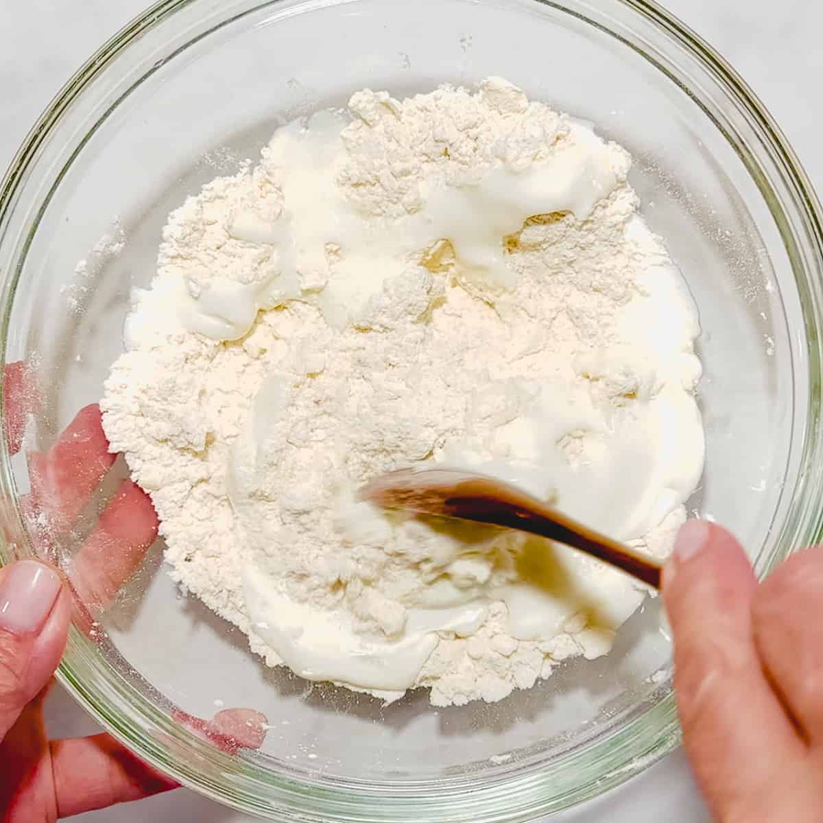 mixing buttermilk into dry ingredients for biscuits.