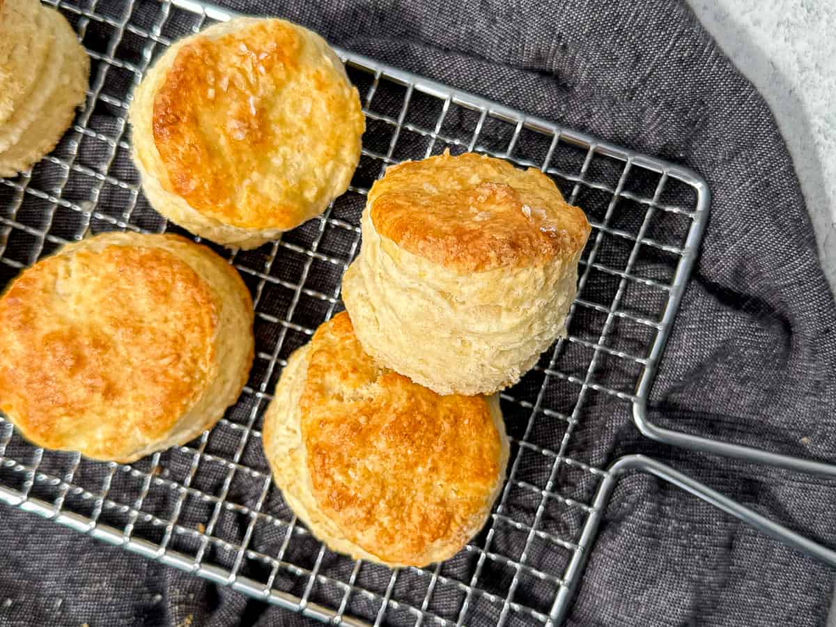 biscuits on a wire rack on top of a blue napkin.