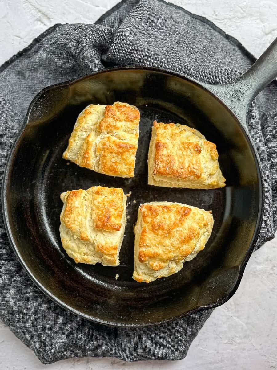 four squarish biscuits in a small cast iron pan.