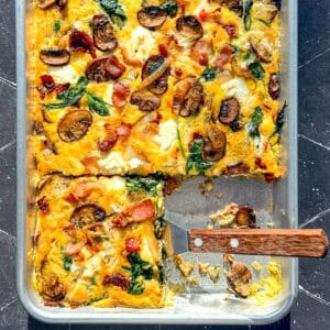 Frittata on a sheet pan with a spatula.