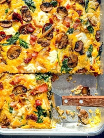Frittata on a sheet pan with a spatula.