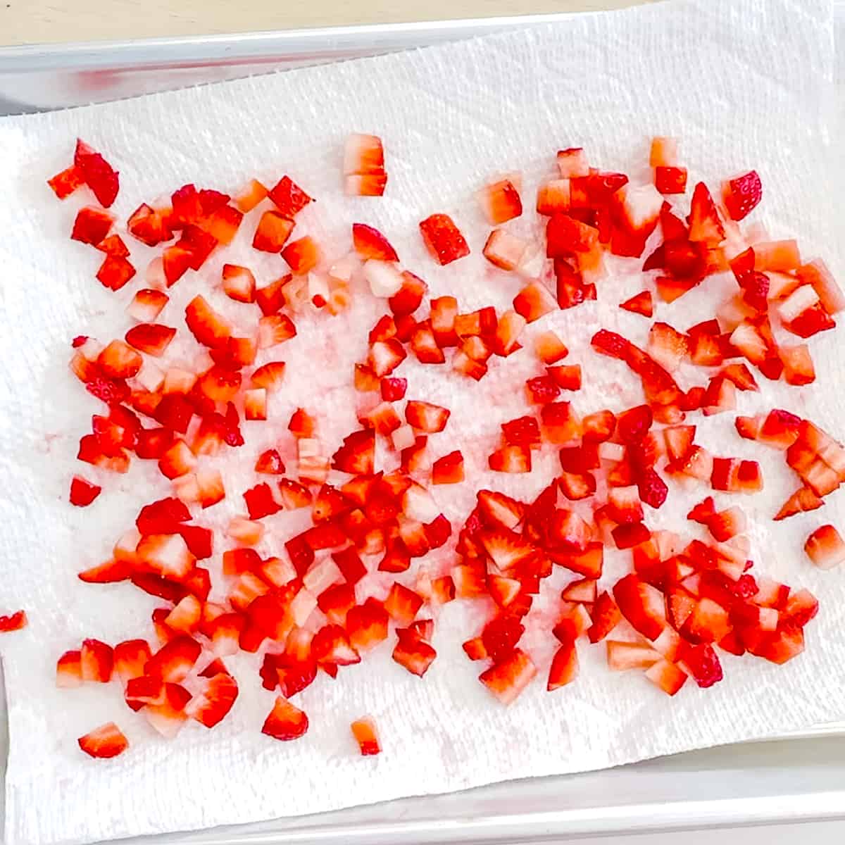 drying diced strawberries on paper towel.