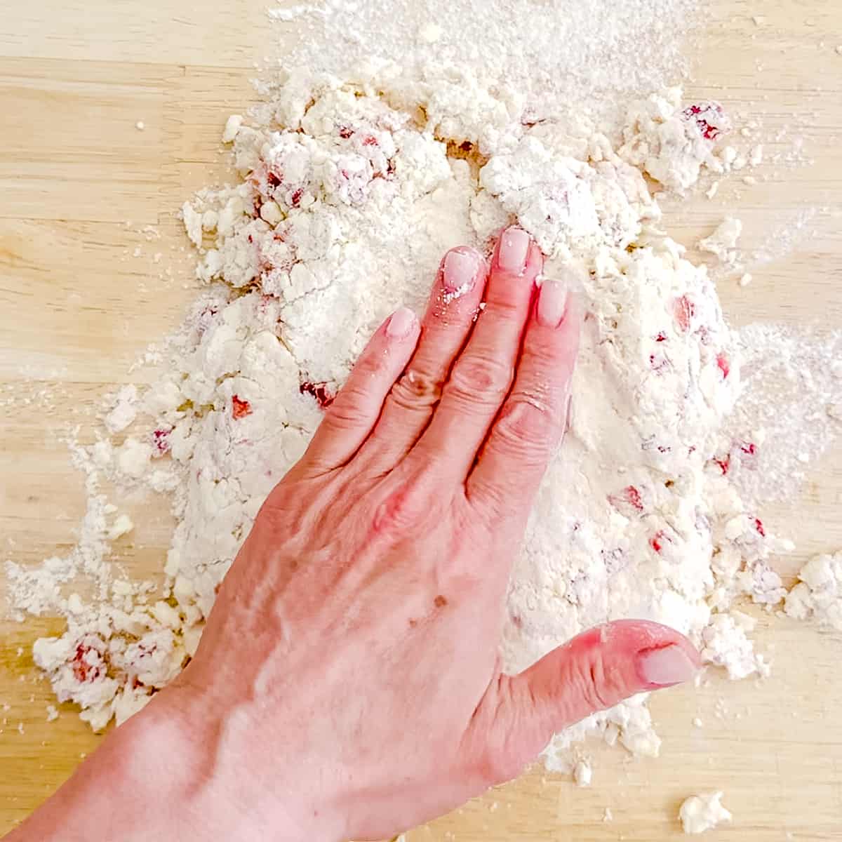 patting out strawberry biscuit dough.