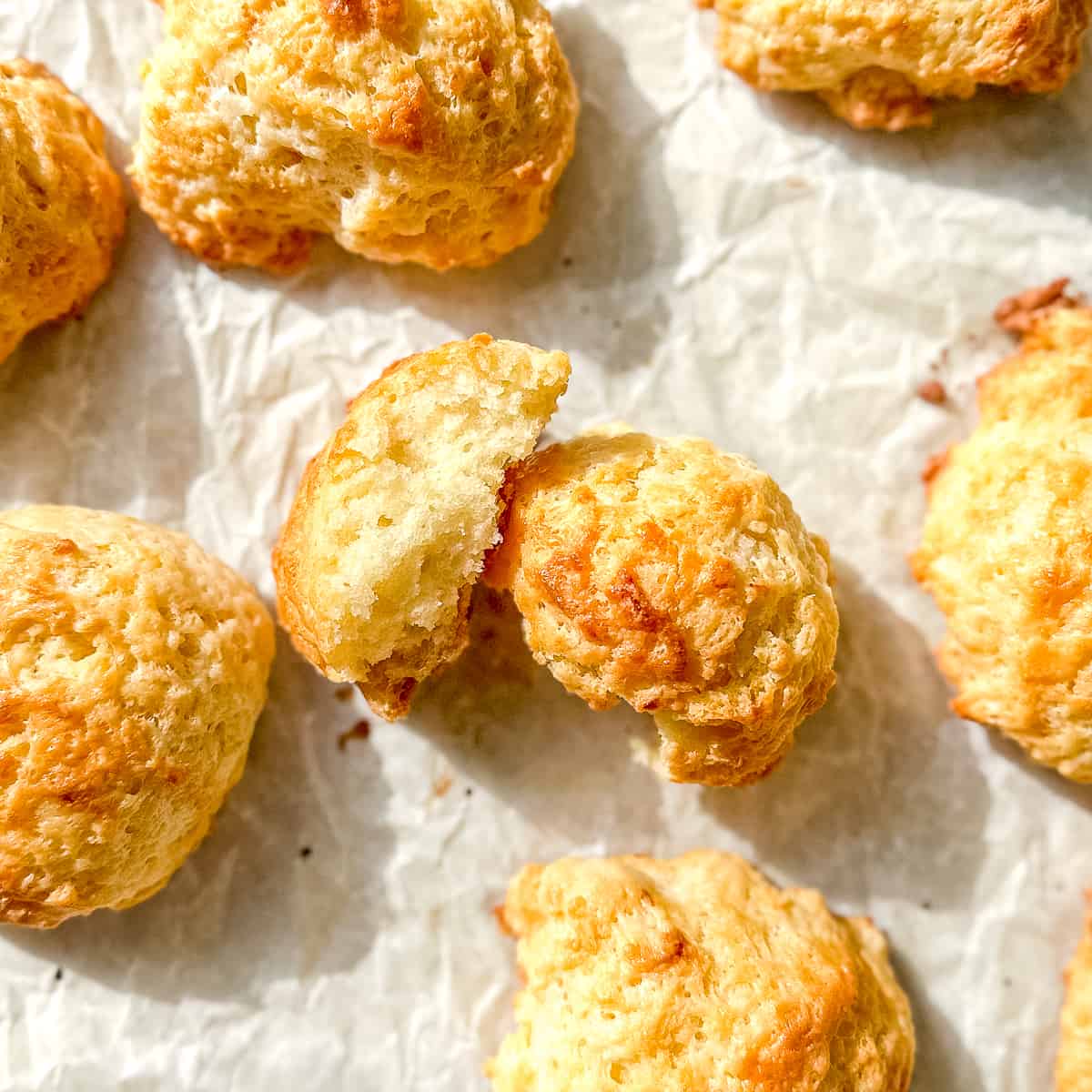 fluffy drop biscuits on parchment paper.