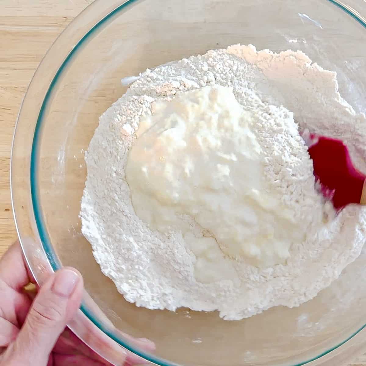 adding butter and buttermilk mixture to biscuit dry ingredients.