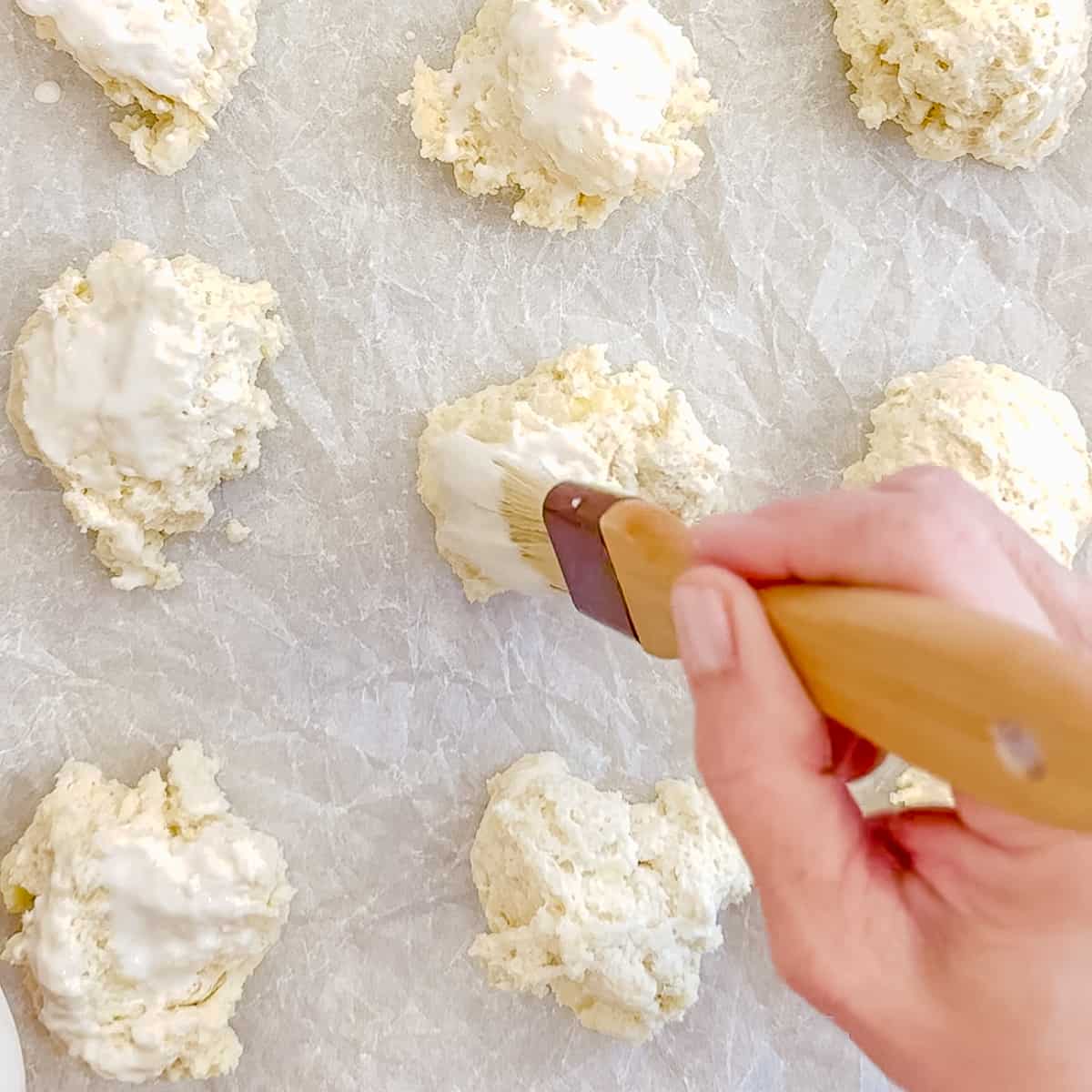 brushing buttermilk over unbaked drop biscuits.