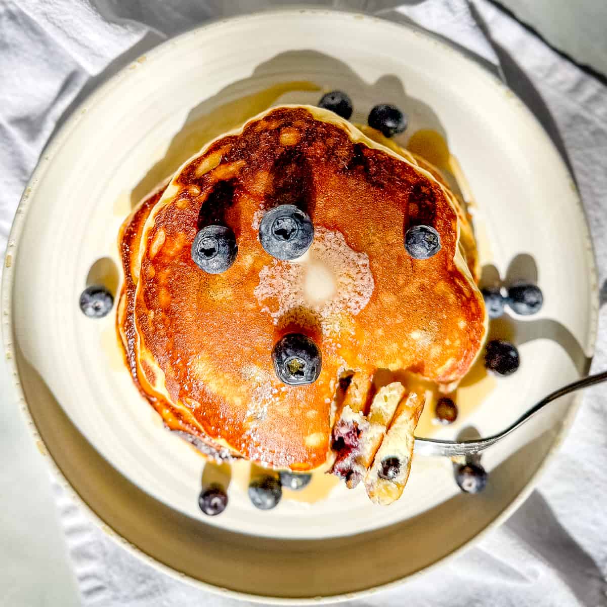 closeup of a forkful of lemon ricotta blueberry pancakes.