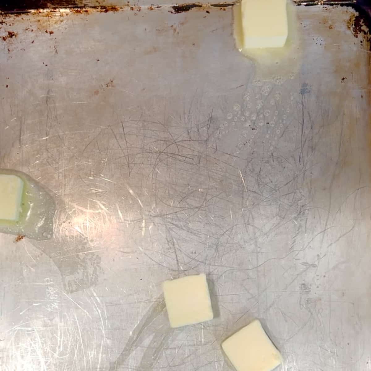 melting butter on a hot sheet pan.