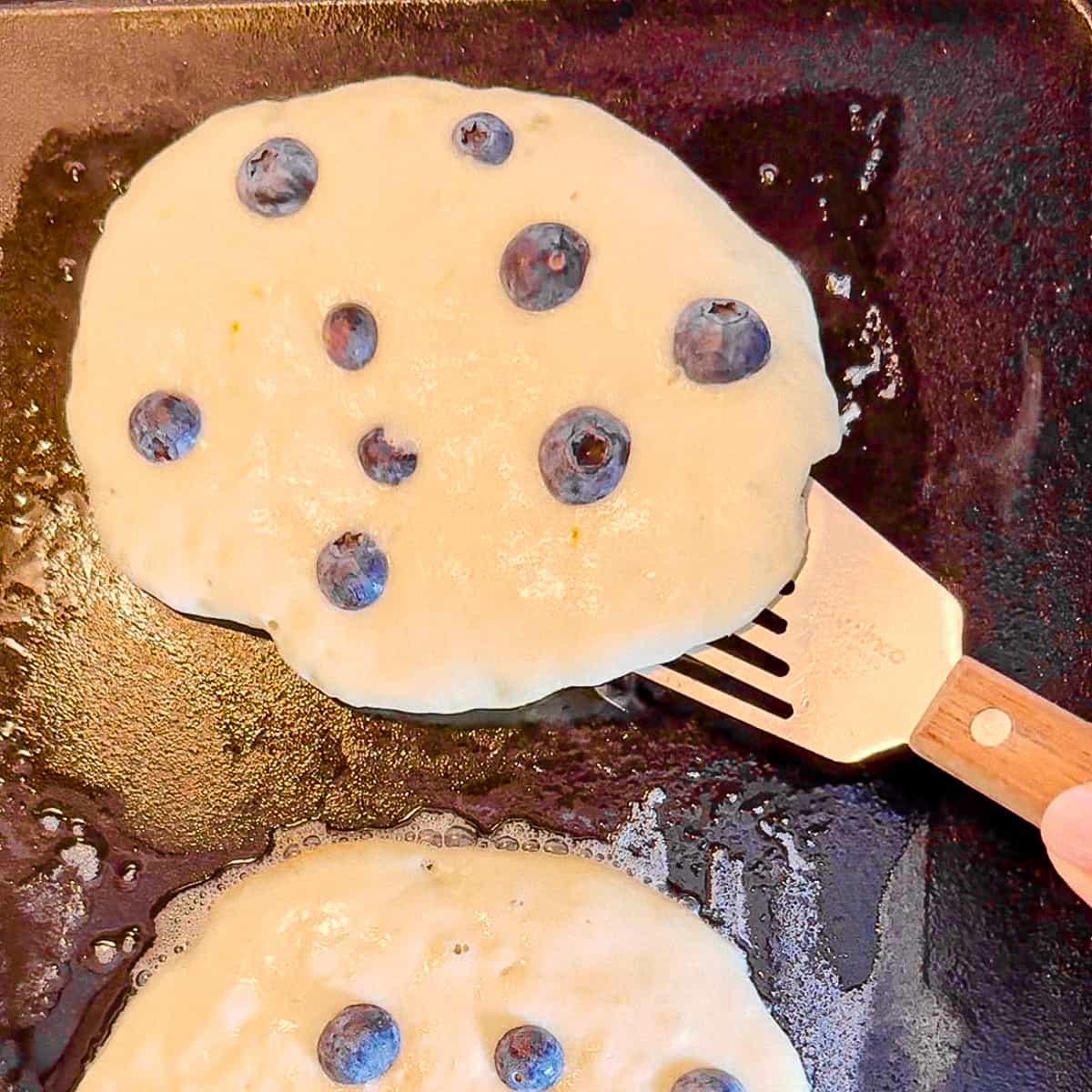 flipping blueberry pancakes.