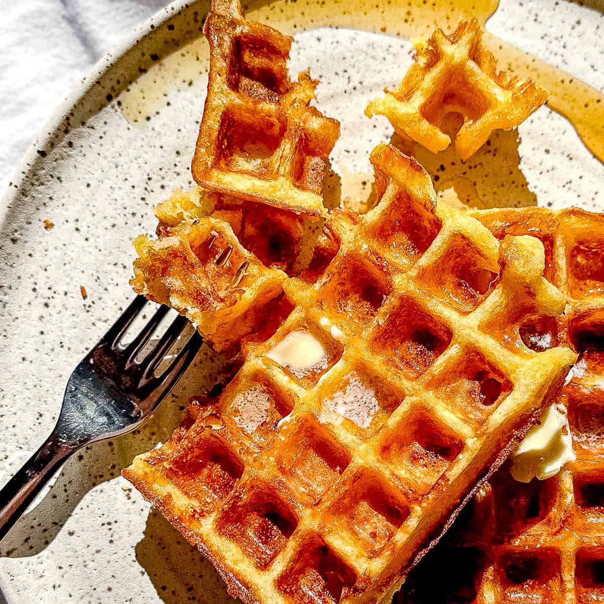 holding a forkful of waffle.