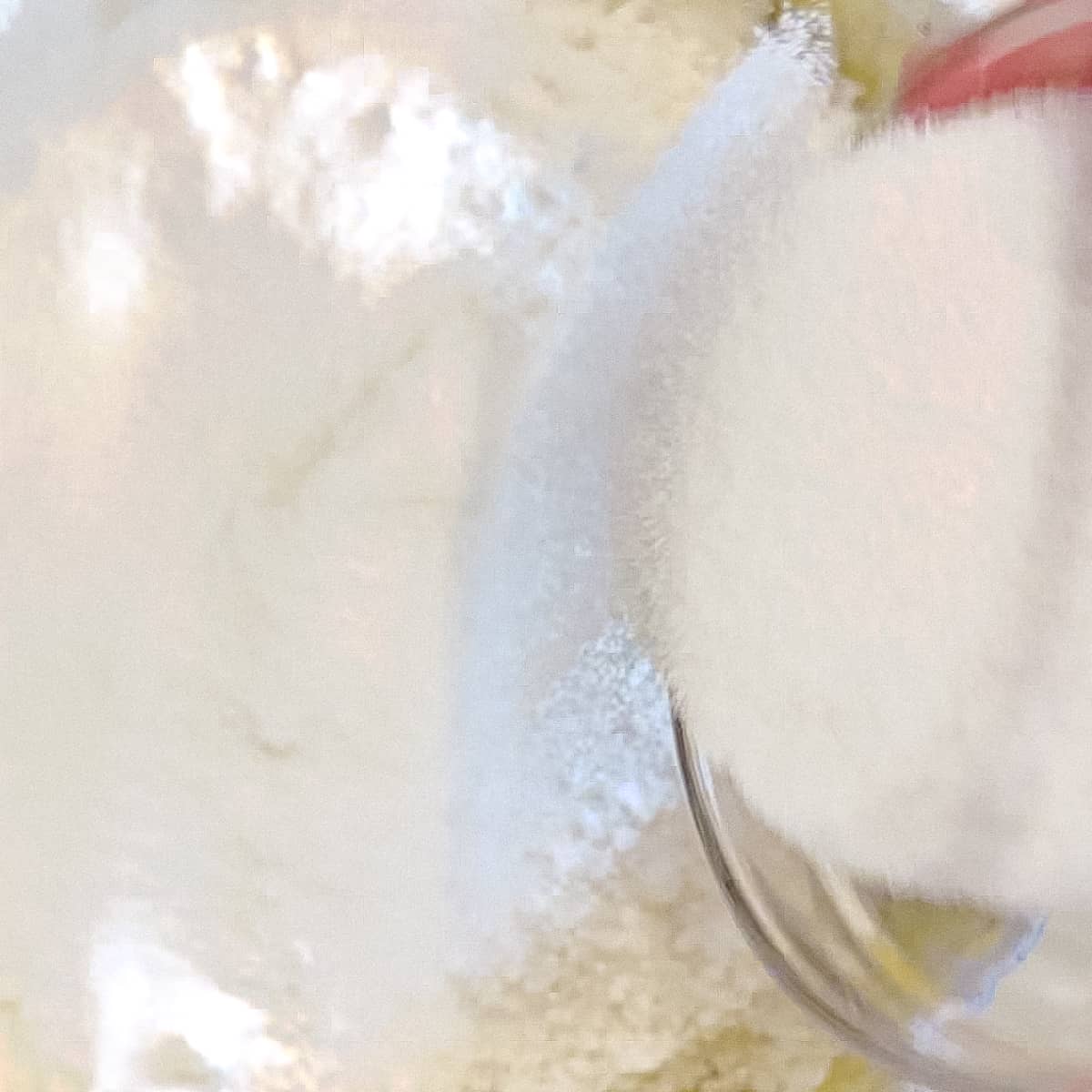 Adding flour and sugar to wet ingredients for one bowl banana bread.