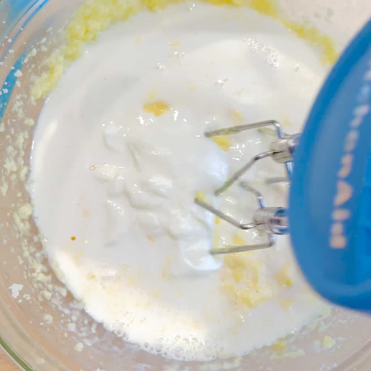 Mixing milk and yogurt into wet ingredients.