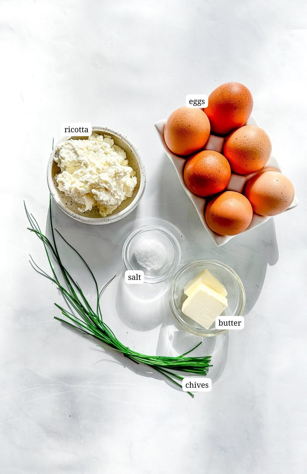 Labeled image of ingredients to make creamy ricotta scrambled eggs.