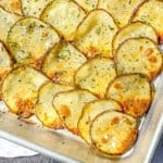 Sheet pan filled with crispy roasted potato slices.