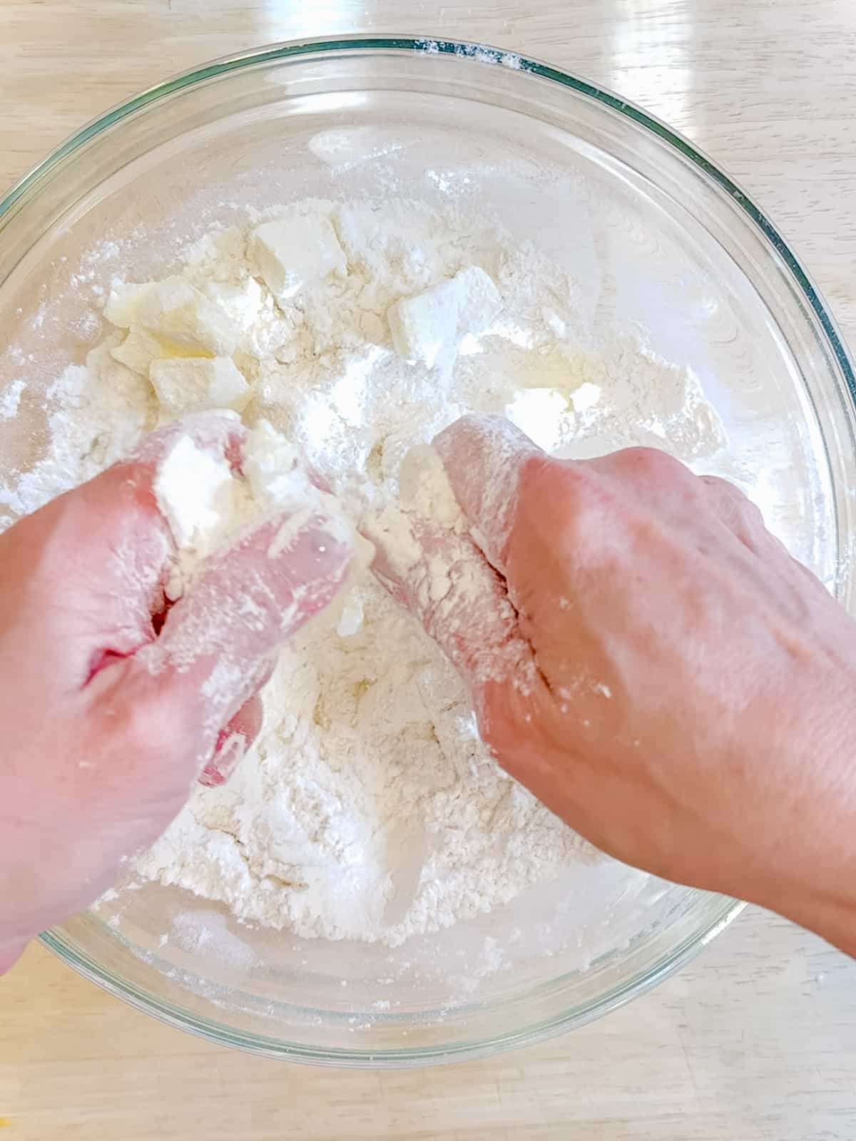 Using a finger snapping motion to cut butter into flour.