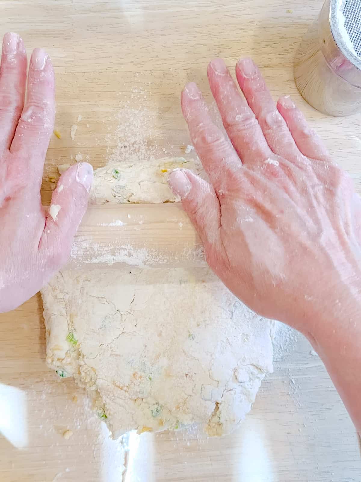 Rolling out jalapeno cheddar biscuit dough.