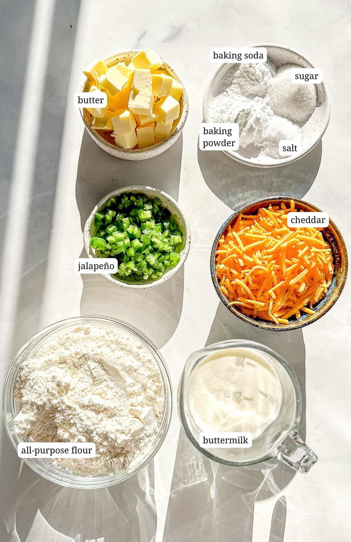 Labeled image showing ingredients to make jalapeno cheddar biscuits.
