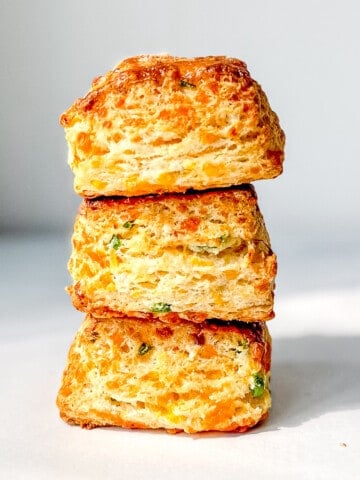 A side view of a stack of jalapeno cheddar biscuits.