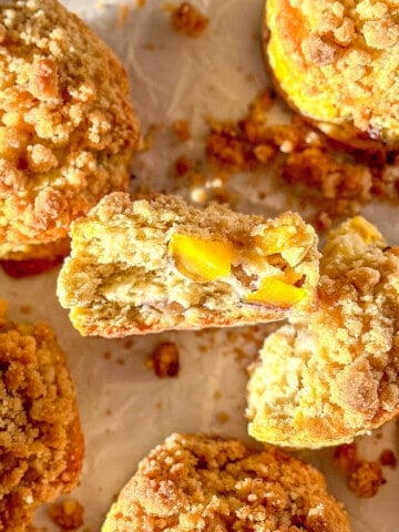 Sheet tray of peach biscuits with streusel topping.