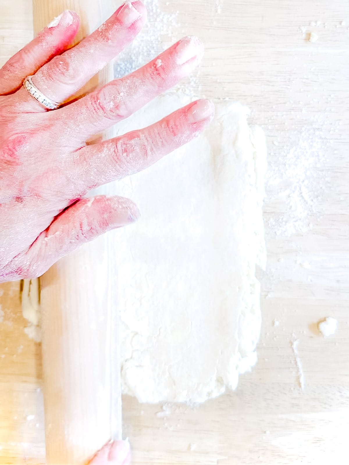 Rolling out biscuit dough.