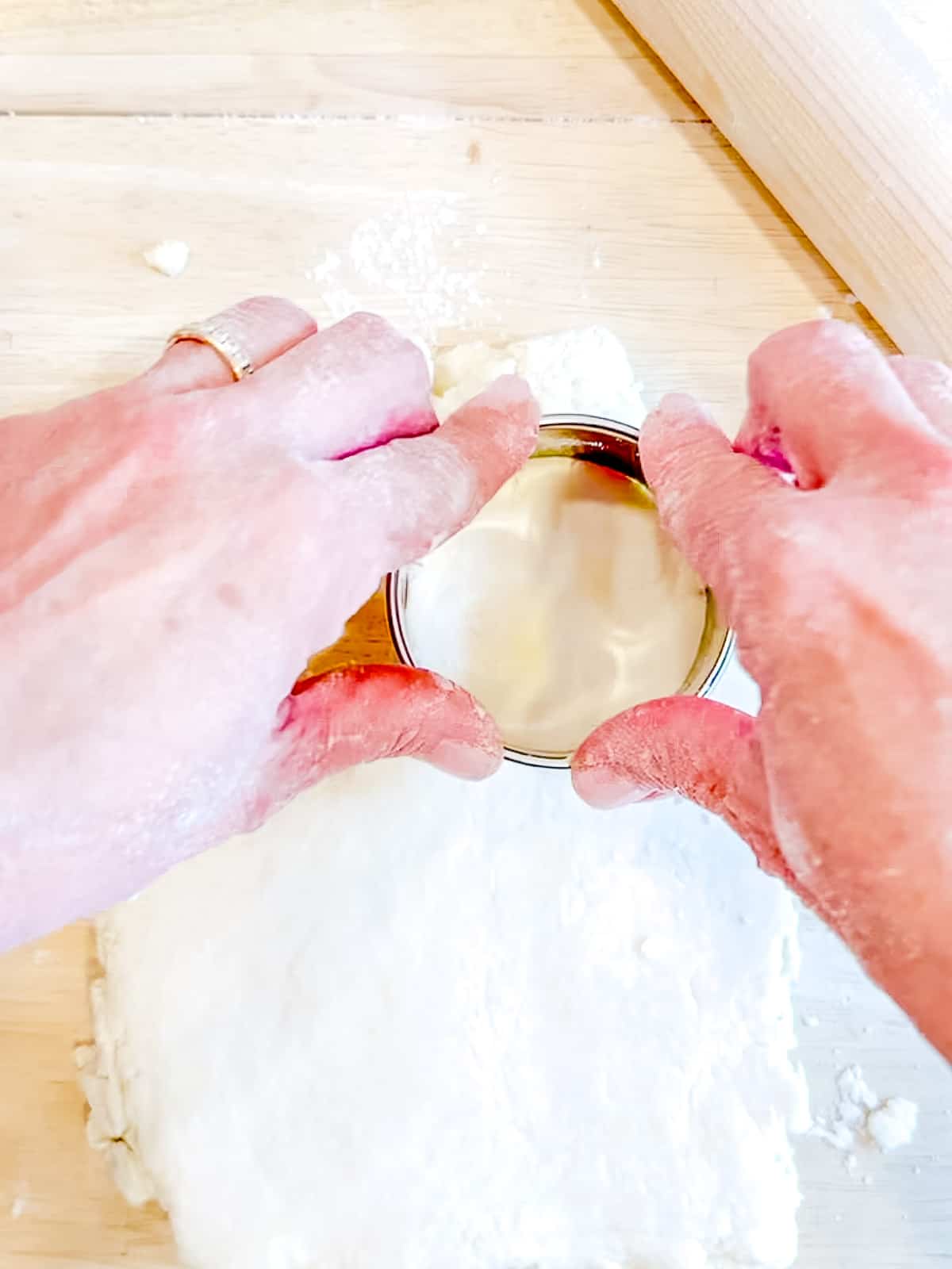 Cutting out easy yogurt biscuits.