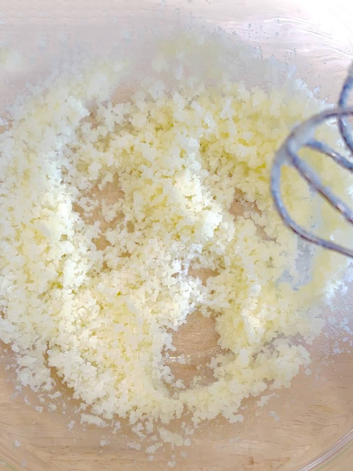 Mixing melted butter and sugar.