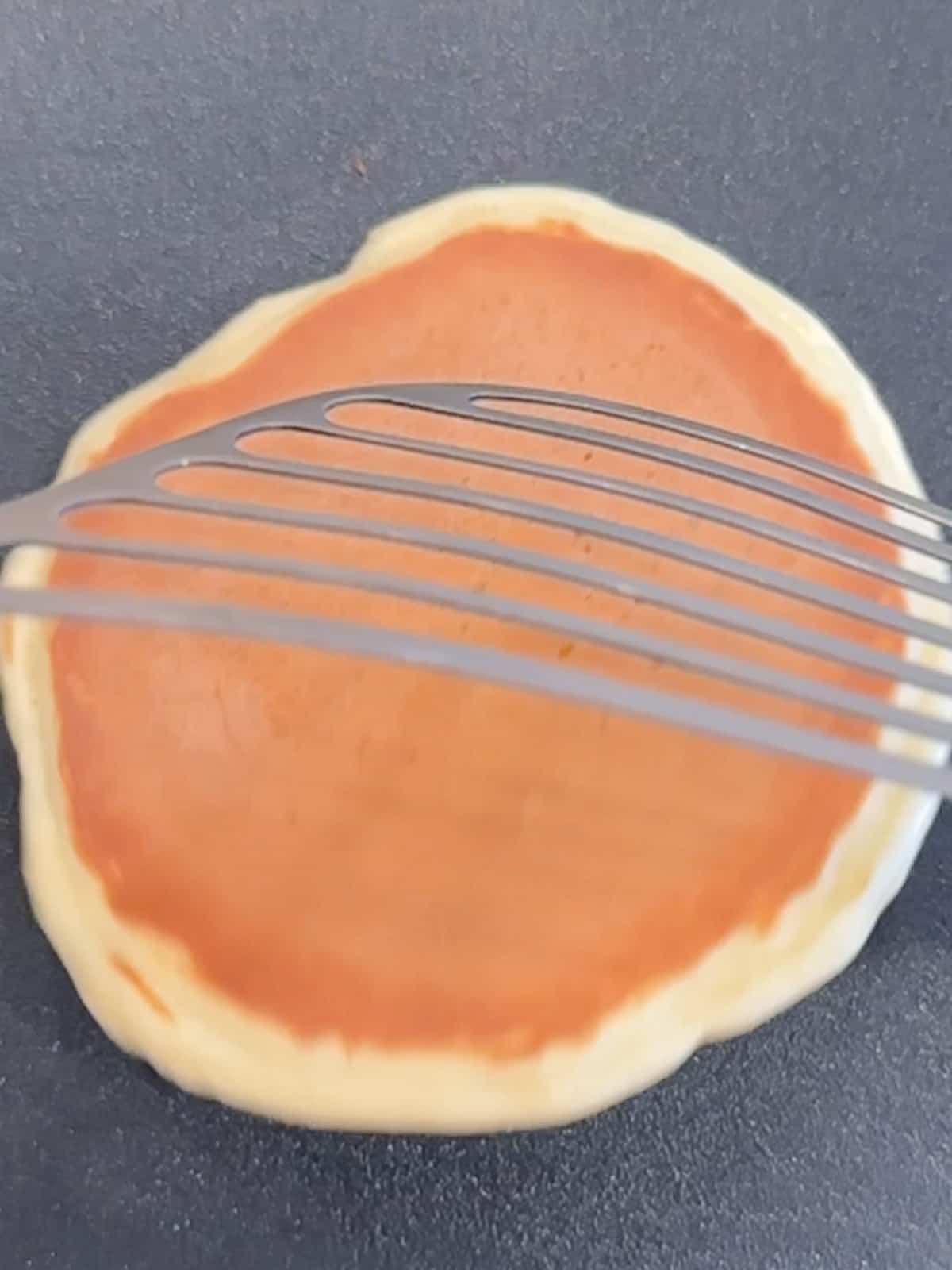 Flipping over a yogurt pancake.