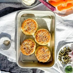 Everything cream cheese biscuits on a sheet pan with more cream cheese, smoked salmon and capers on the side.