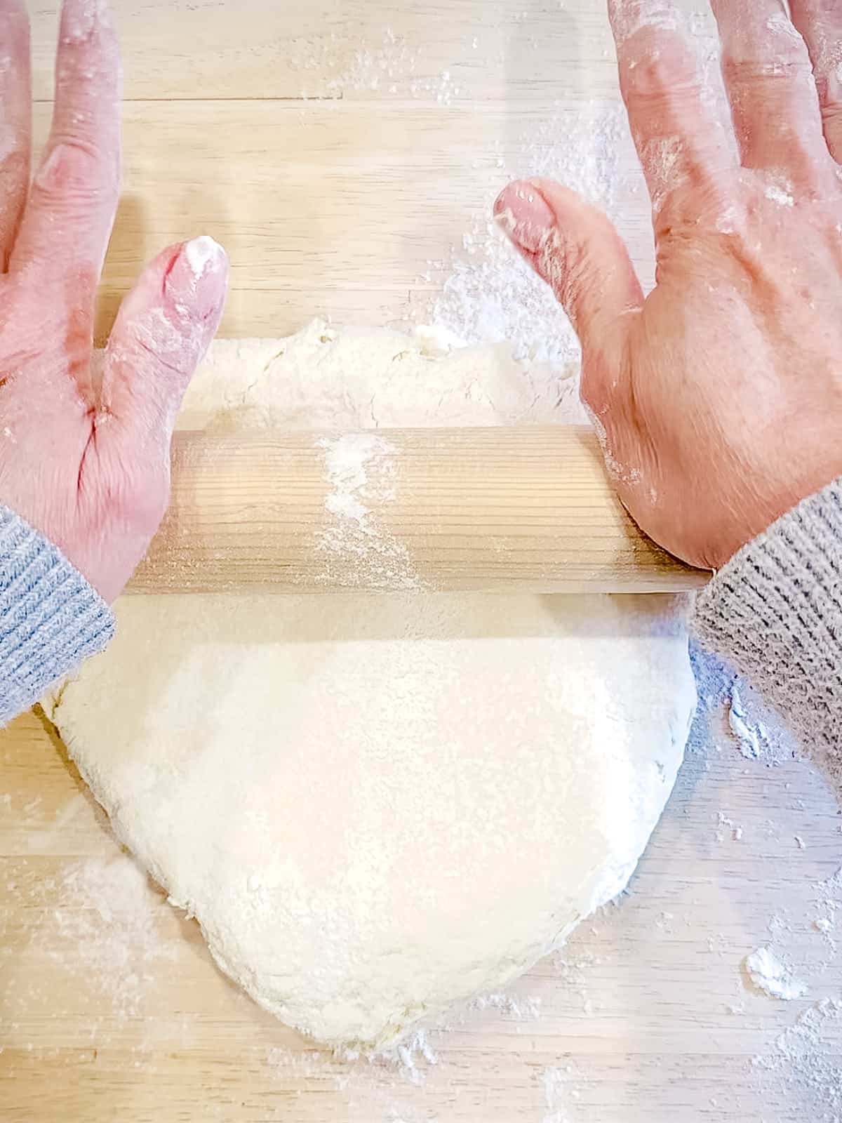 Rolling out cream biscuit dough.