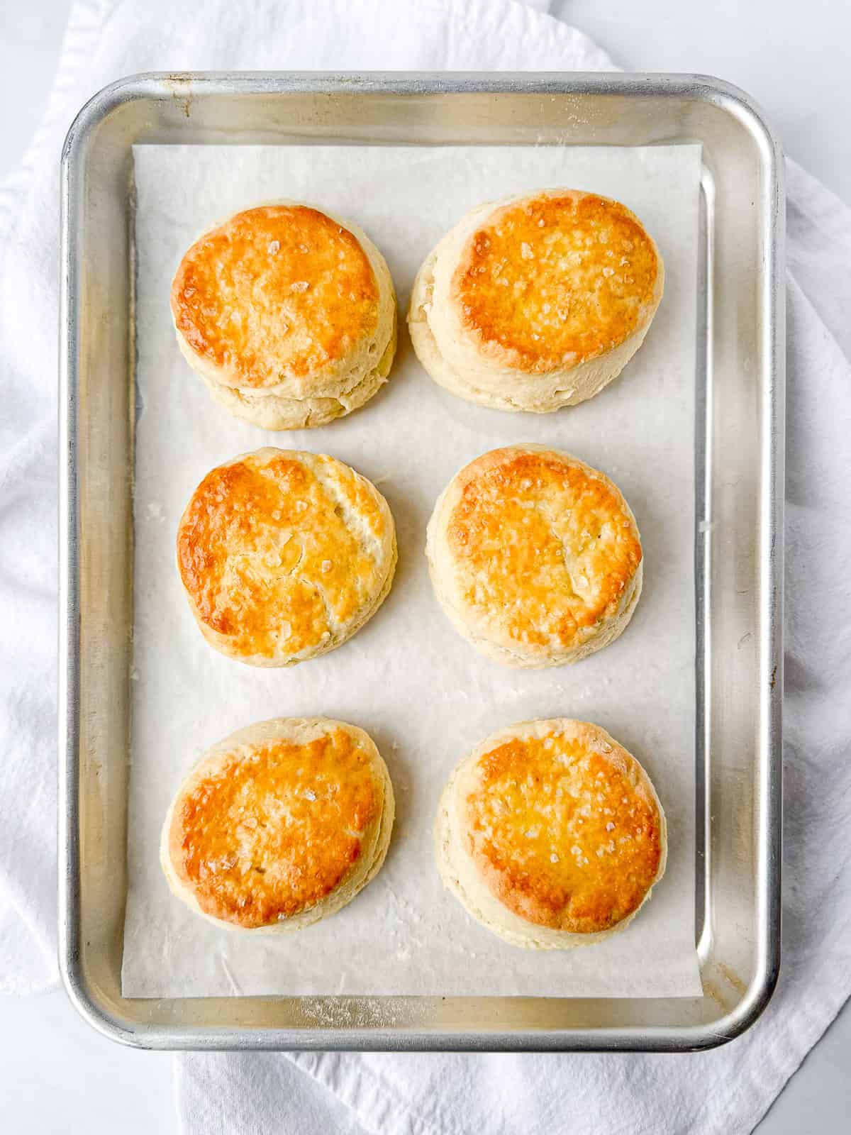 Vertical image of six 5 ingredient cream biscuits.