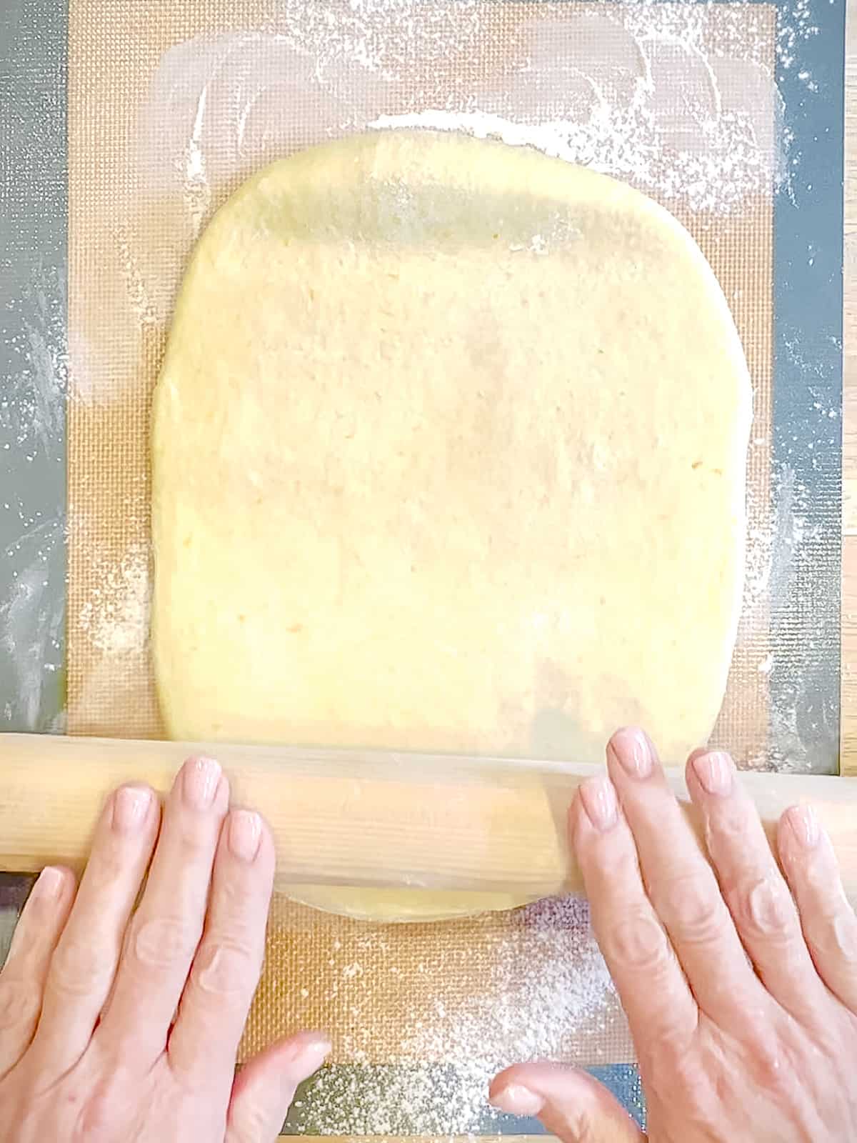 Rolling out cinnamon roll dough