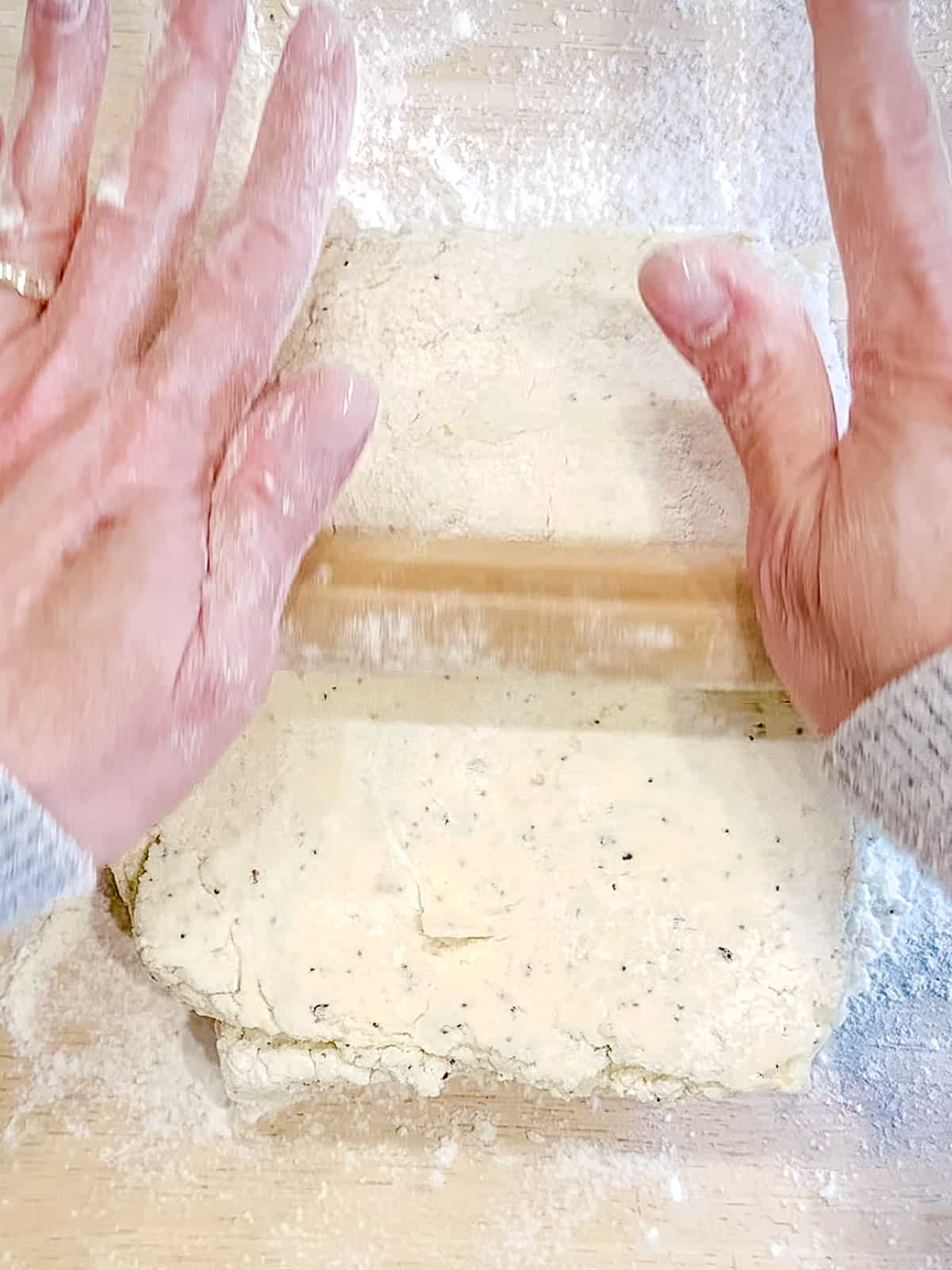Rolling out everything bagel cream cheese biscuit dough.