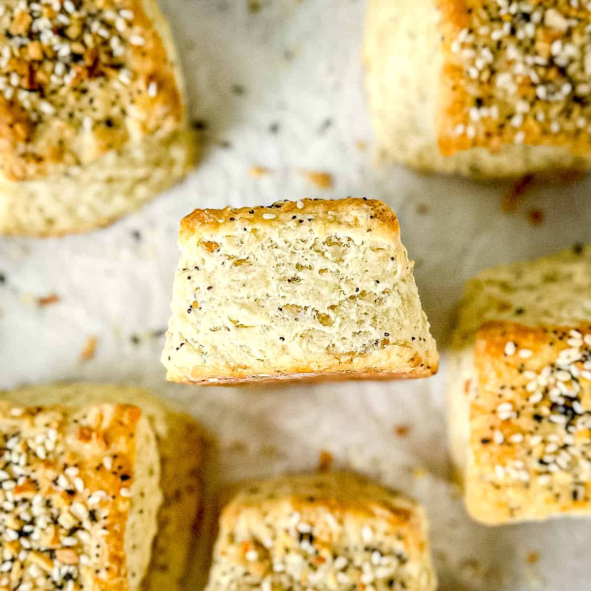 Everything bagel cream cheese biscuits on a parchment paper lined sheet pan.