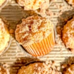 Sour cream coffee cake muffins in a muffin pan.