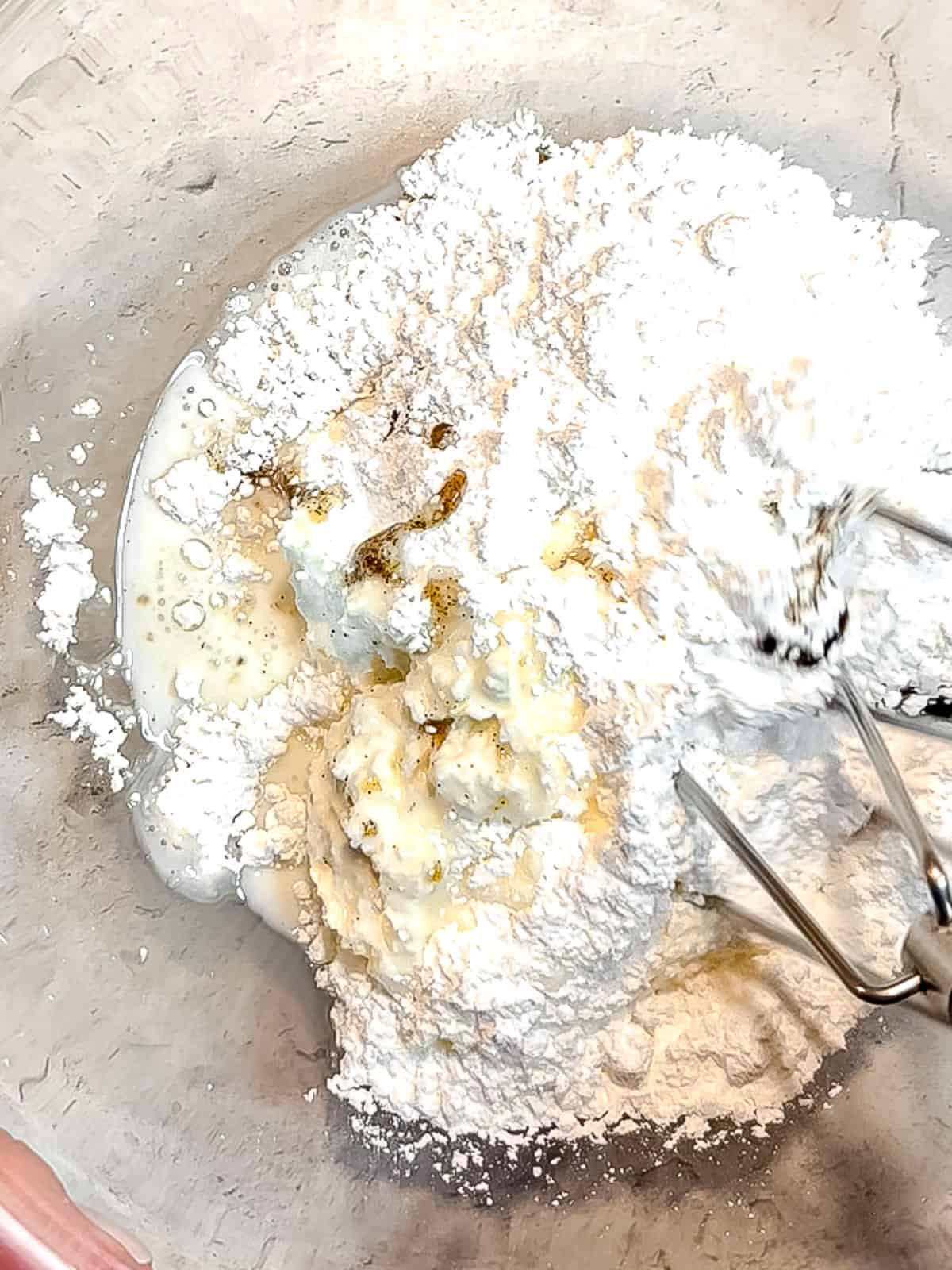 Mixing orange cream cheese frosting.