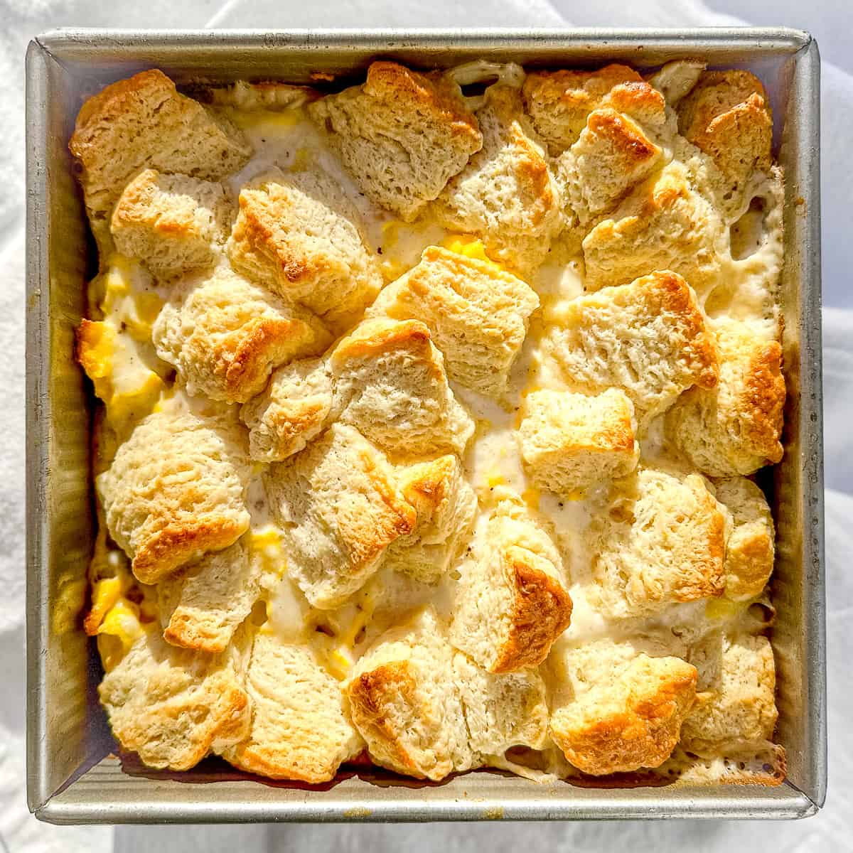 Biscuits and Gravy breakfast casserole topped with homemade buttermilk biscuits.