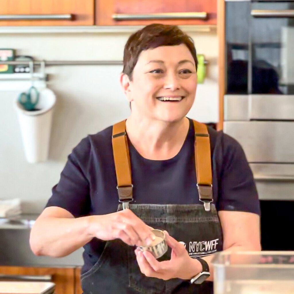 Cynthia teaching a brunch class and smiling.