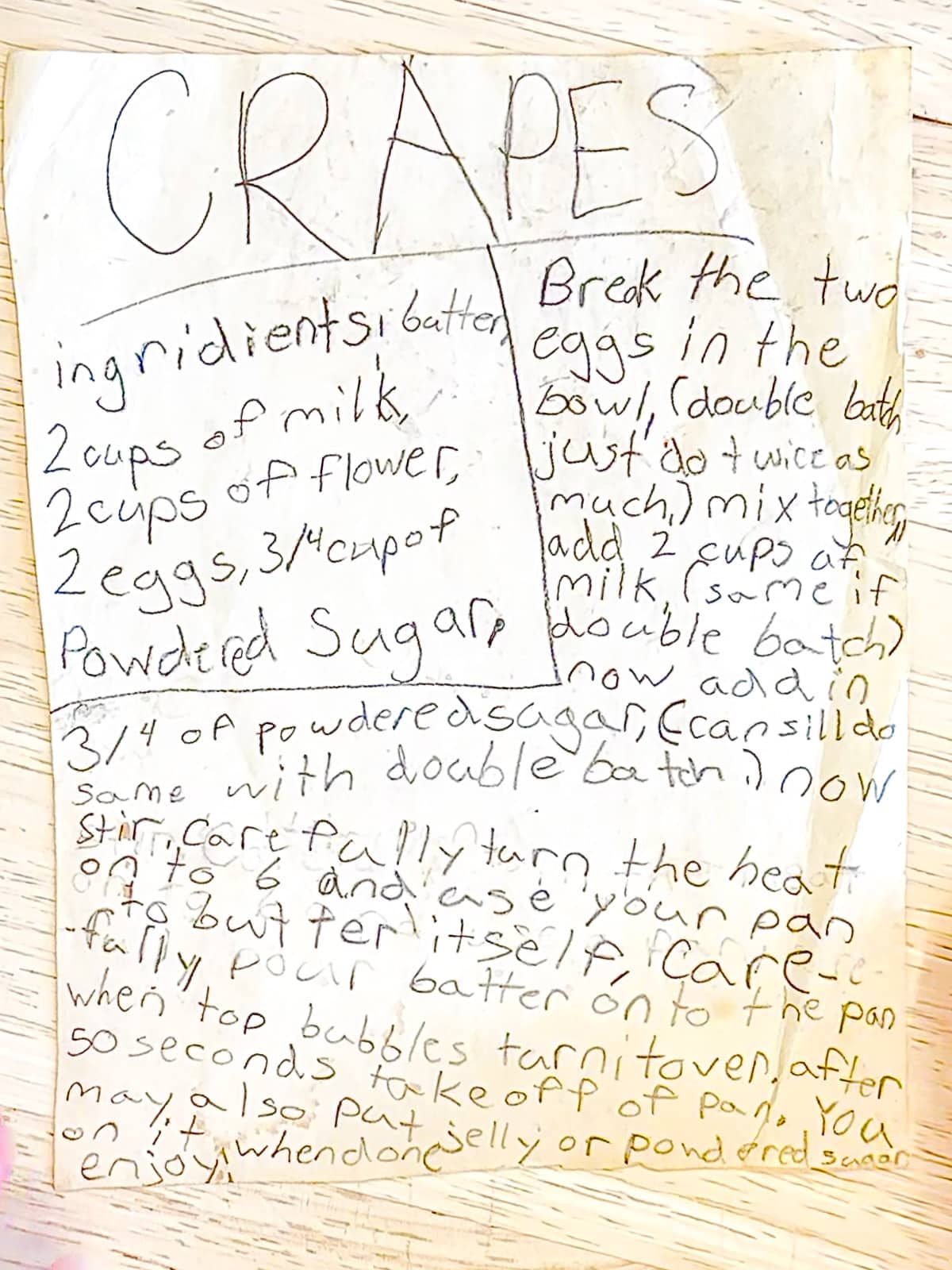 A crêpes recipe written in a children's handwriting on old paper.