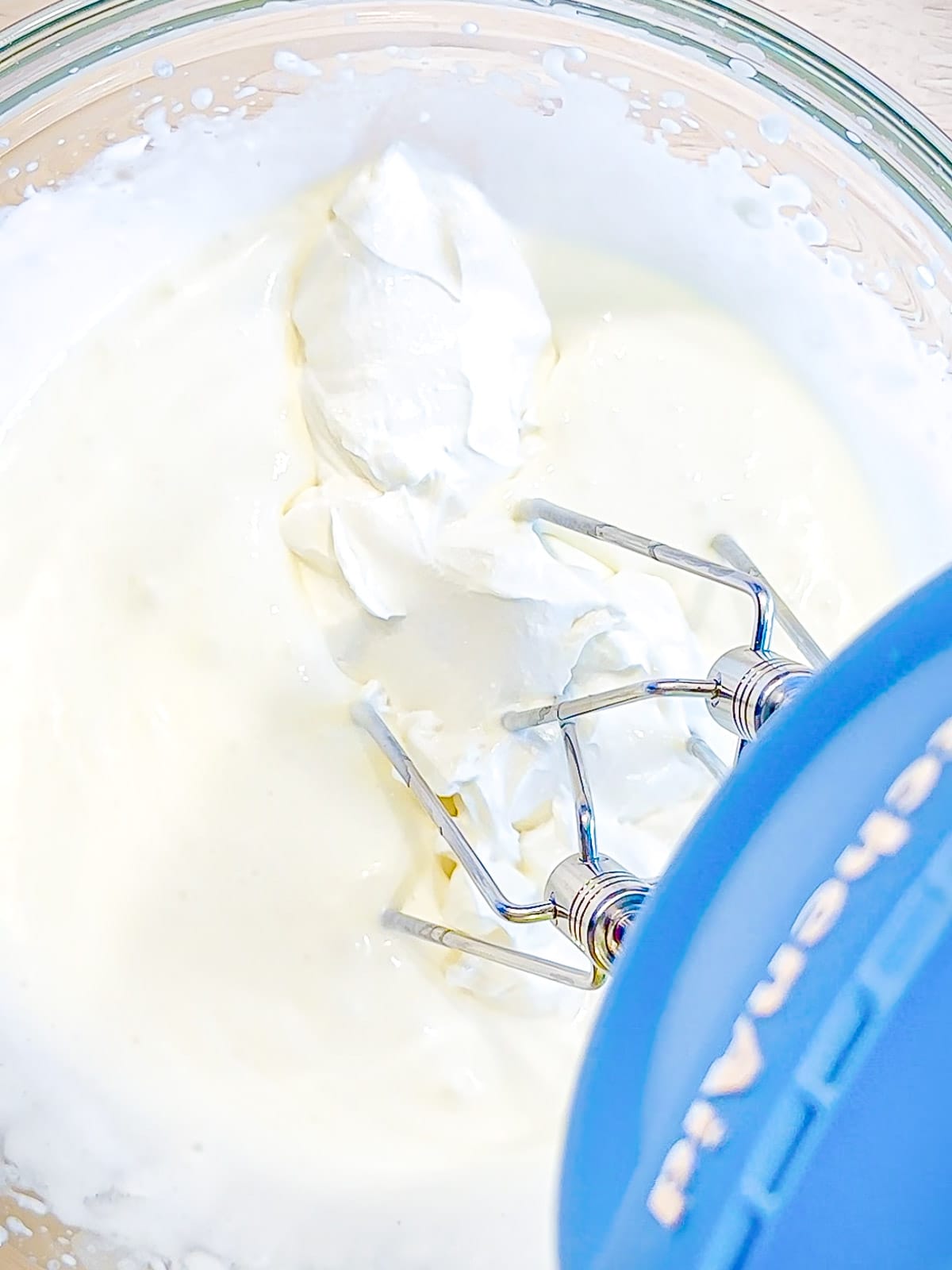 Whipping Greek yogurt into heavy cream.