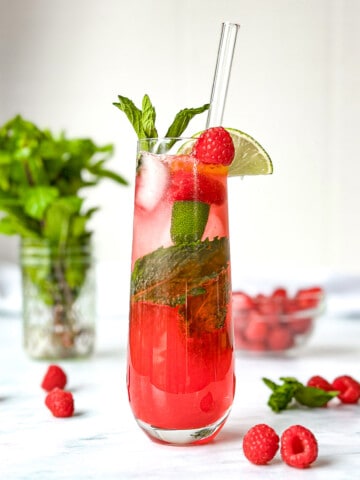 Raspberry Mojito Mocktail in a tall champagne flute.