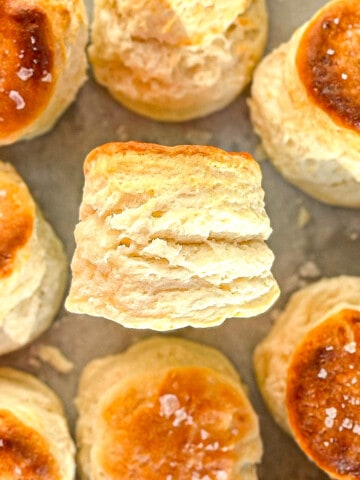Close up side view of a flaky and fluffy two ingredient biscuit.