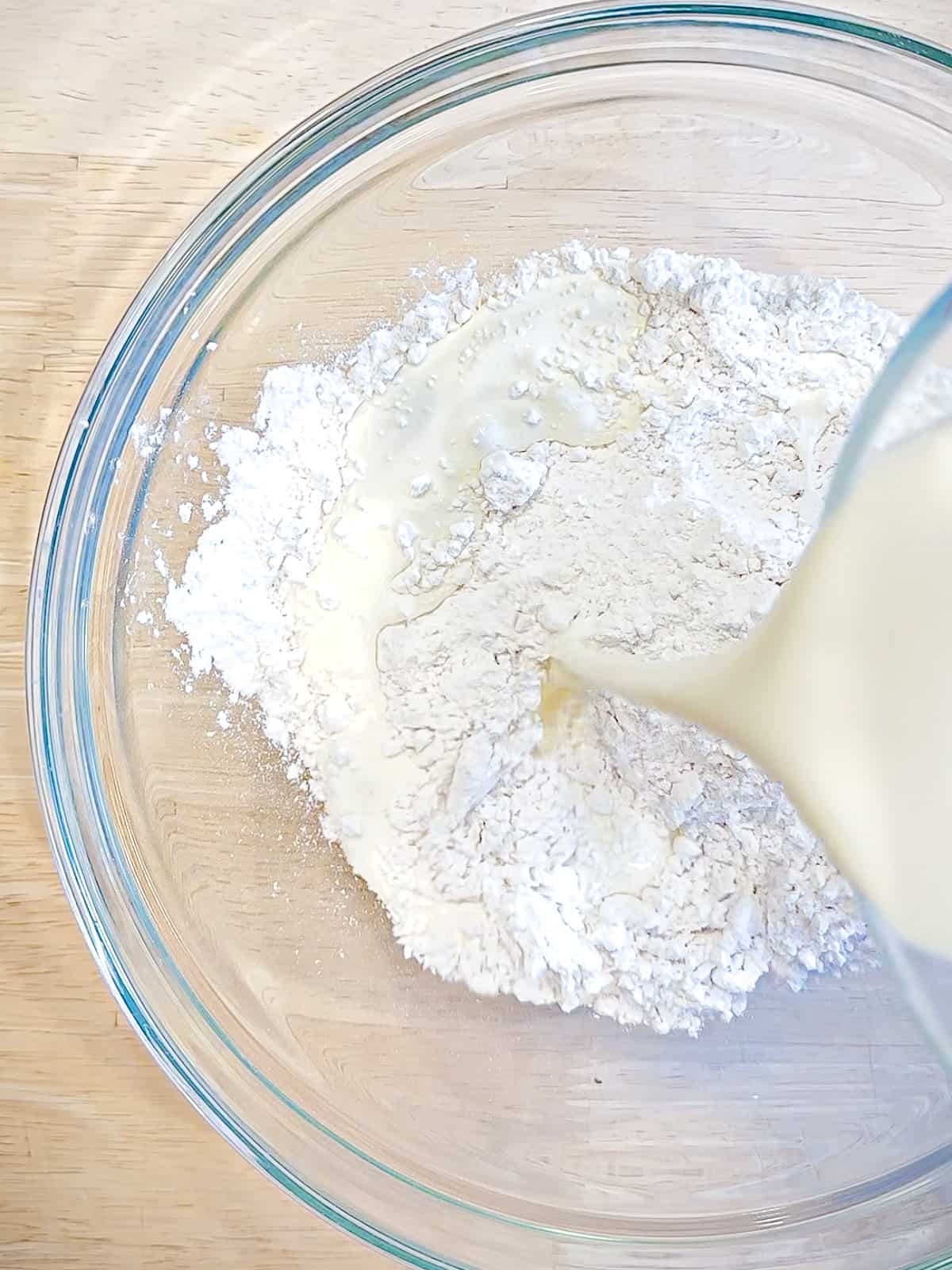 Adding heavy cream to self rising flour, to make biscuits.