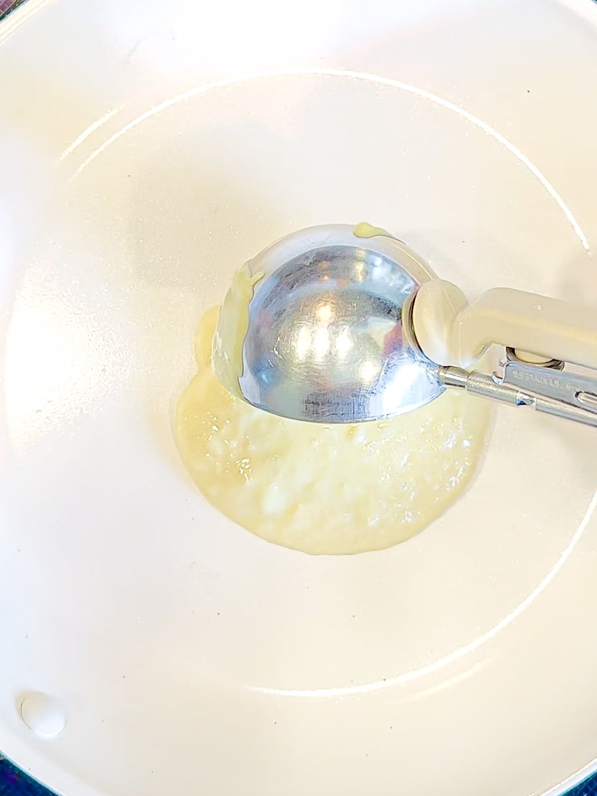 Using a large scoop to portion out three ingredient, pancake batter.