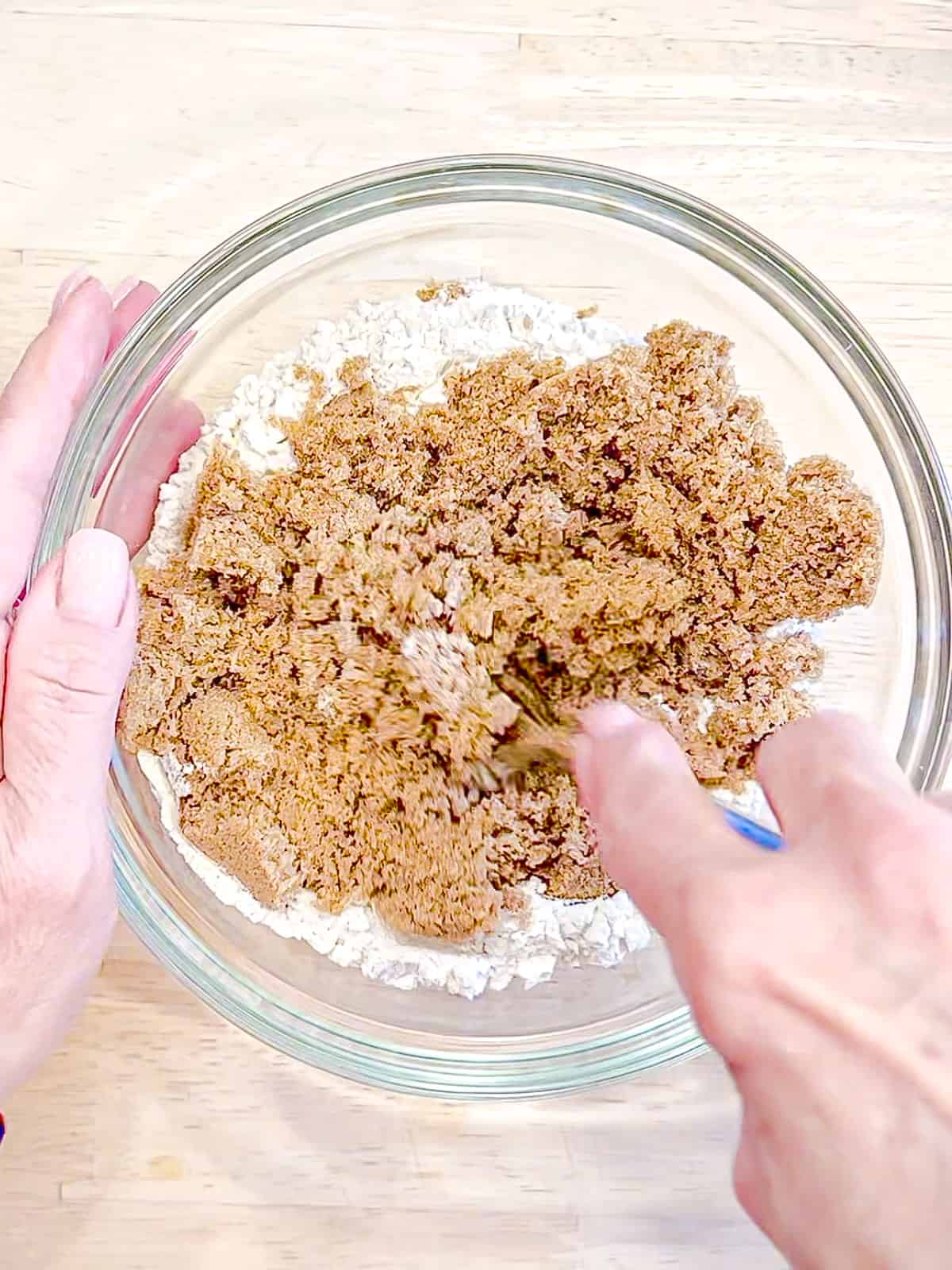 Using a fork to mix dry ingredients to make streusel topping.