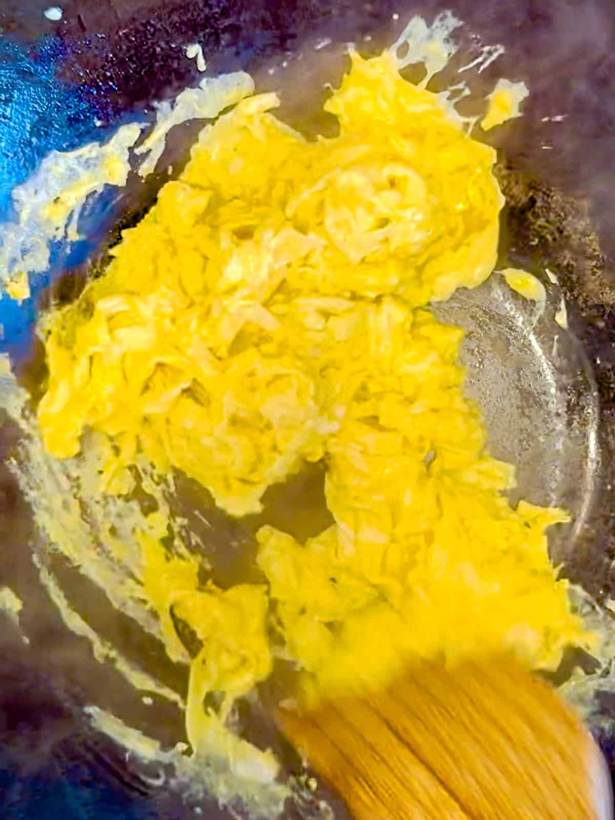 Scrambling eggs in a wok.