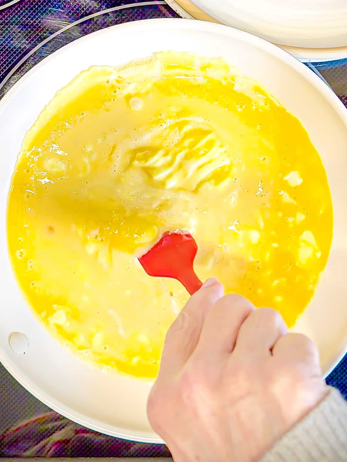 Scrambling eggs in a nonstick pan.