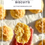 I Pinterest image of a hand holding a broken open easy cheddar bay biscuit.