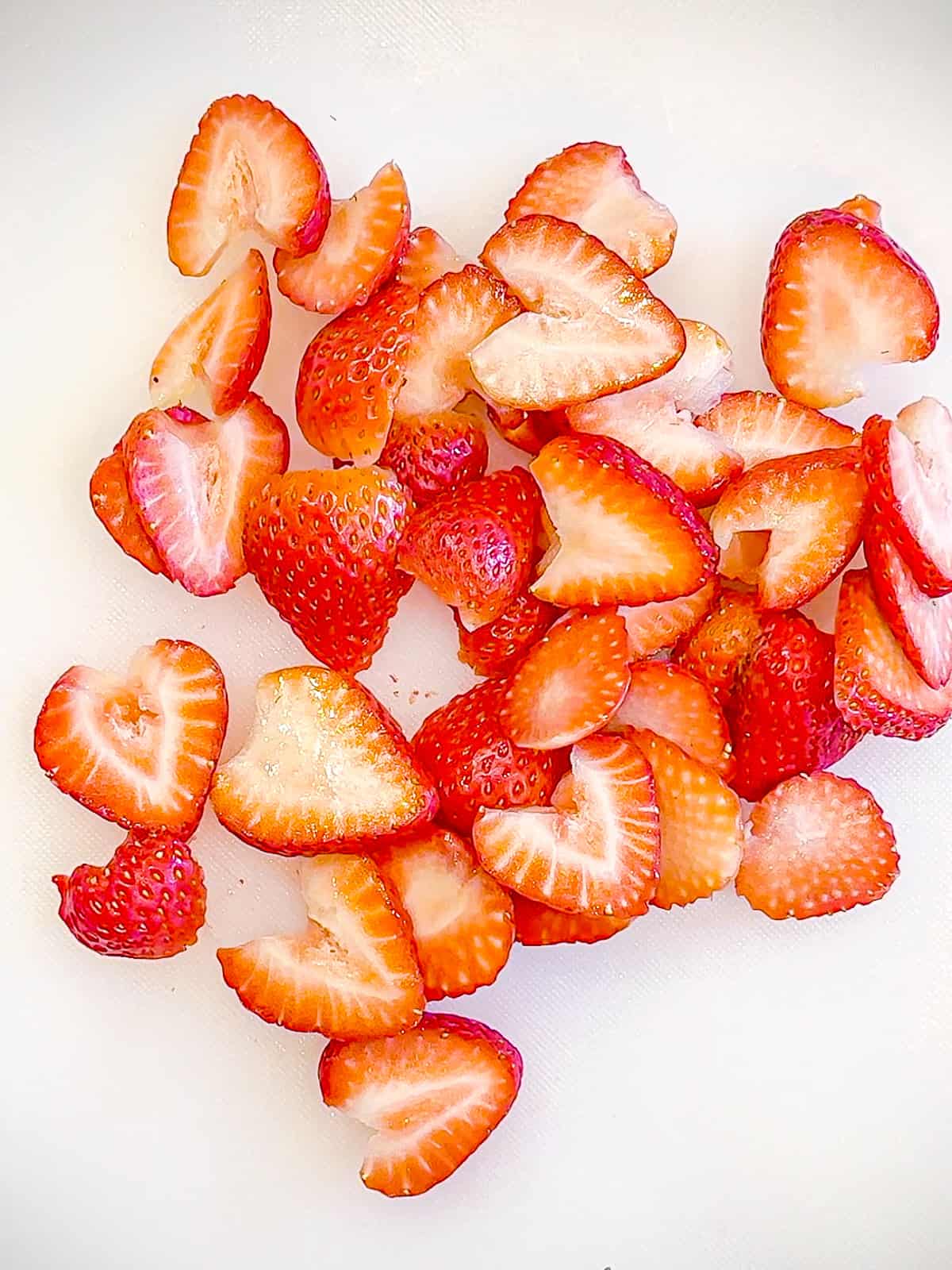 Slicing strawberries for strawberry sheet pan pancakes.