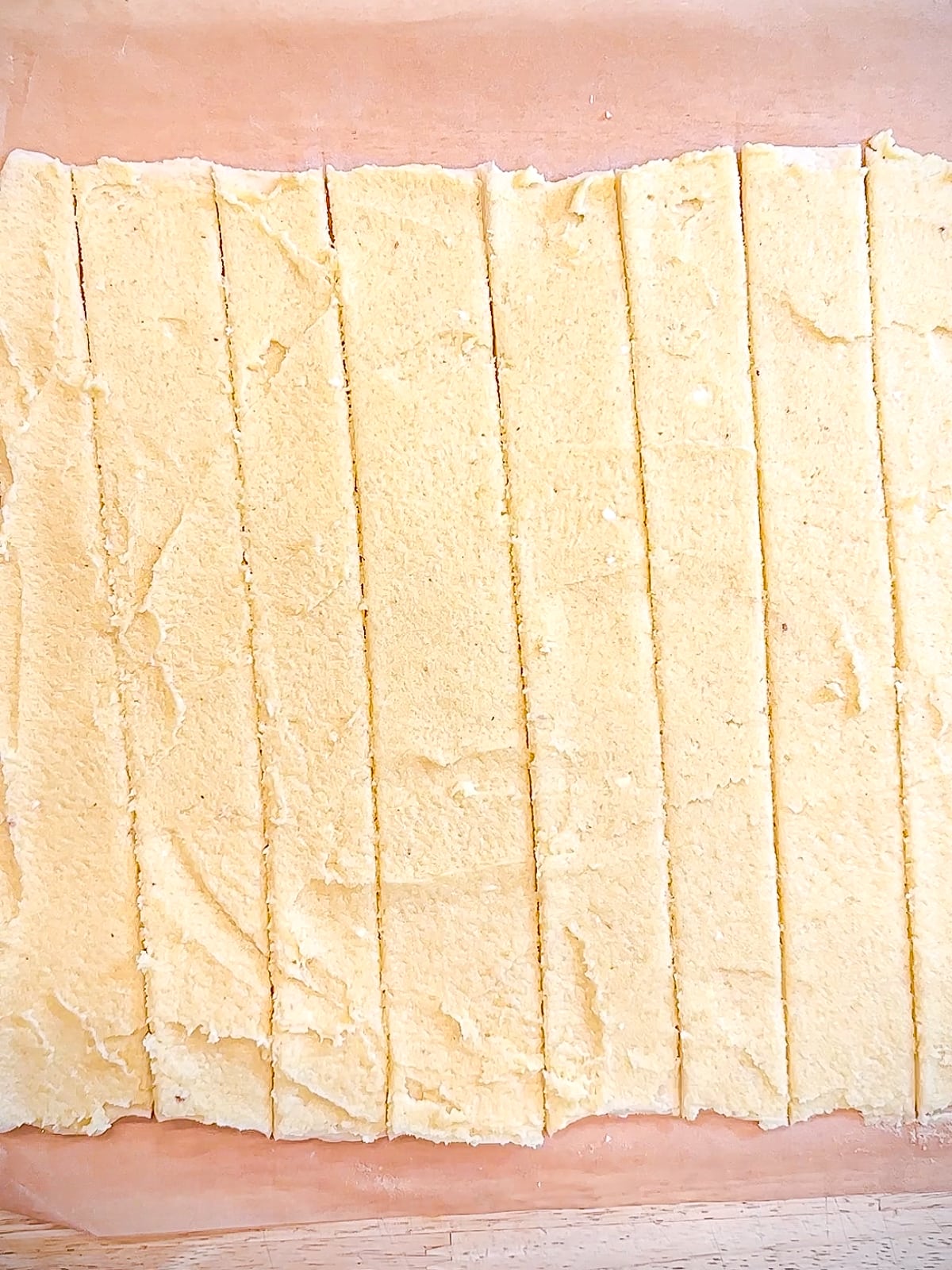 Almond cream covered crescent dough cut into strips.